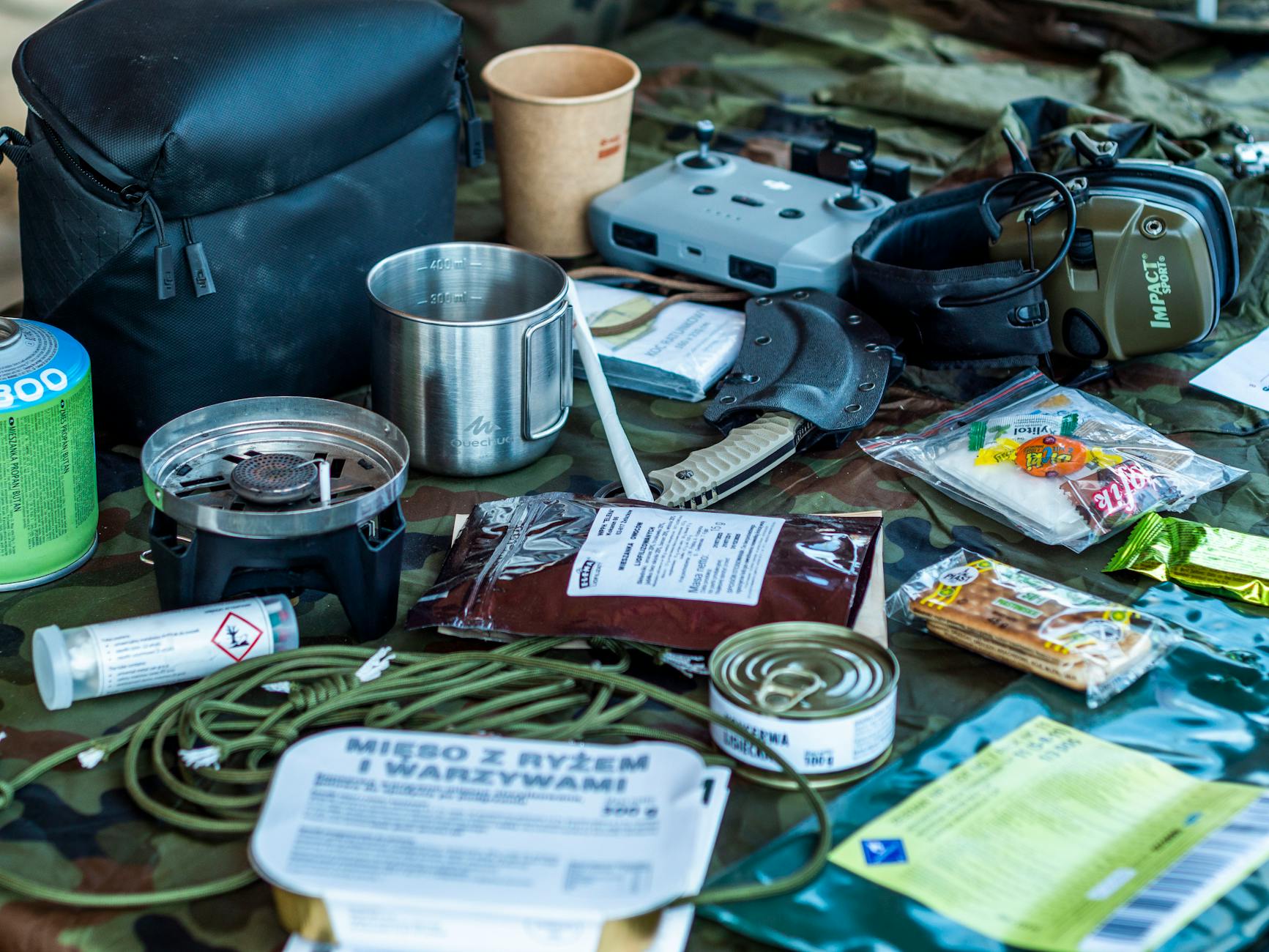 Organized backcountry elk hunting gear laid out by category including pack, optics, shelter, and clothing