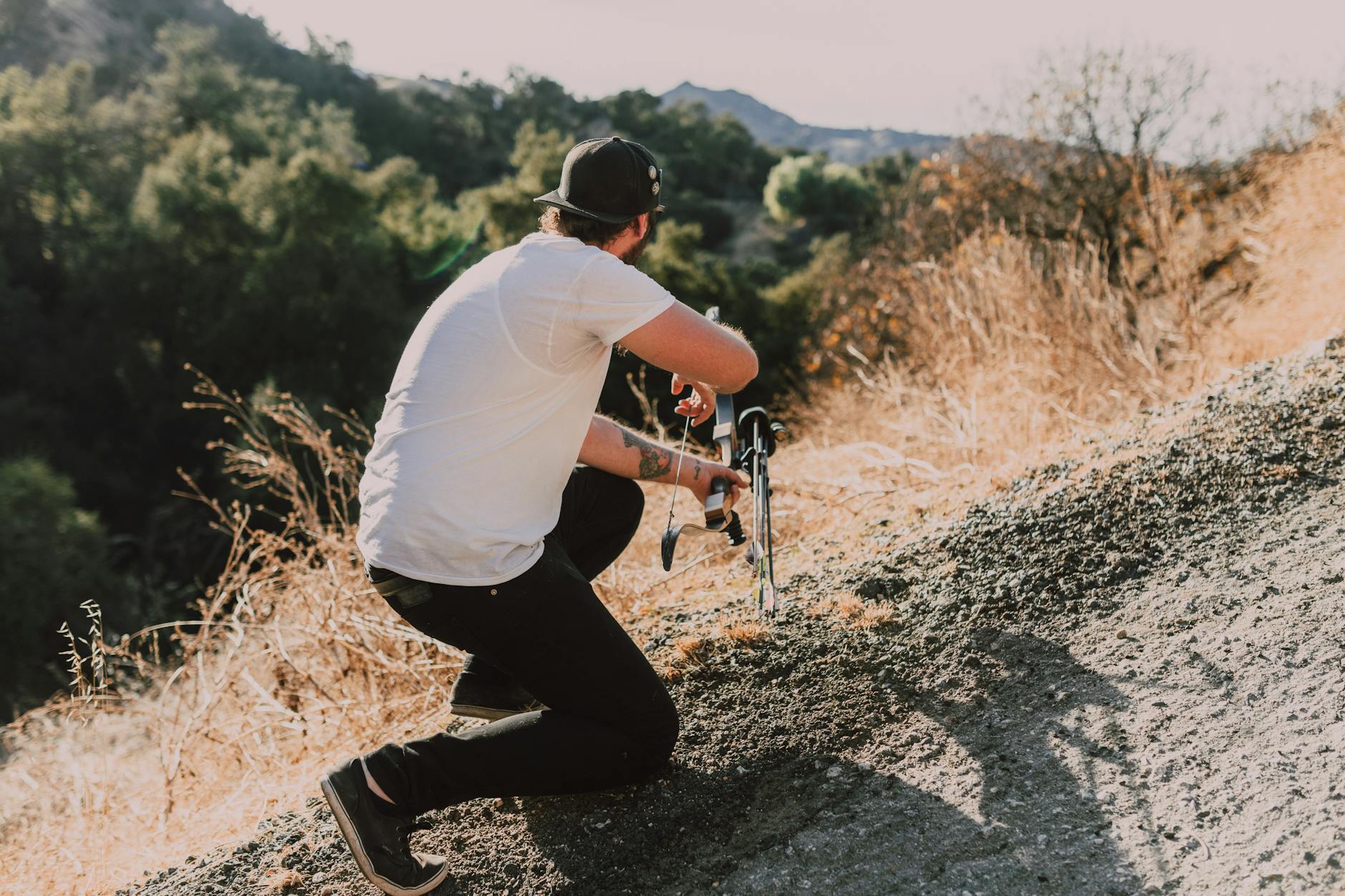 Two hunters with large frame packs traversing a steep ridgeline above timberline during elk season